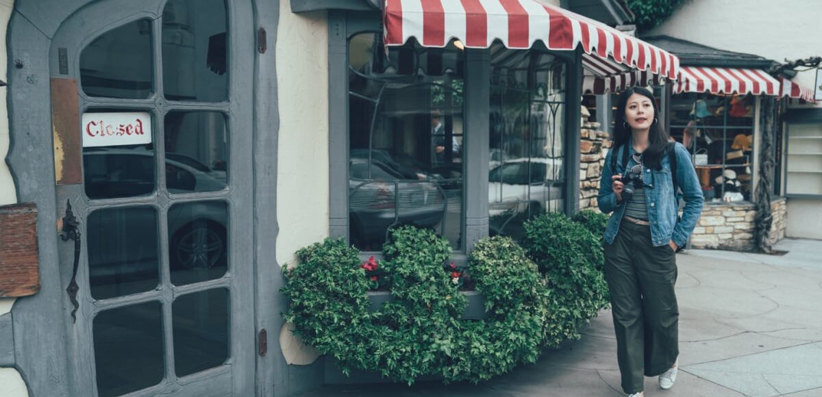 Woman walking through European-esque streets of Carmel, CA