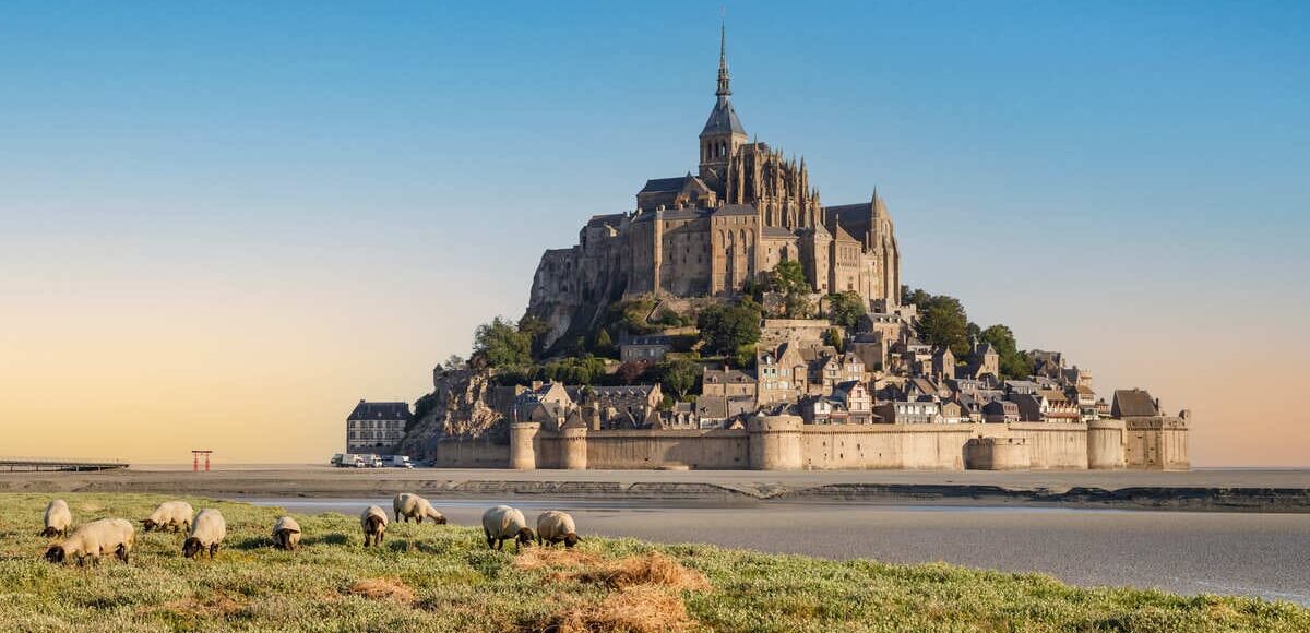 Mont Saint Michel Seen From A Sheep Farm During High Tide, France