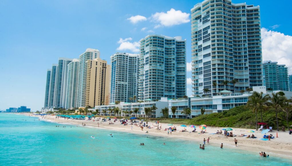 People swimming at nice beach in Sunny Isles, FL