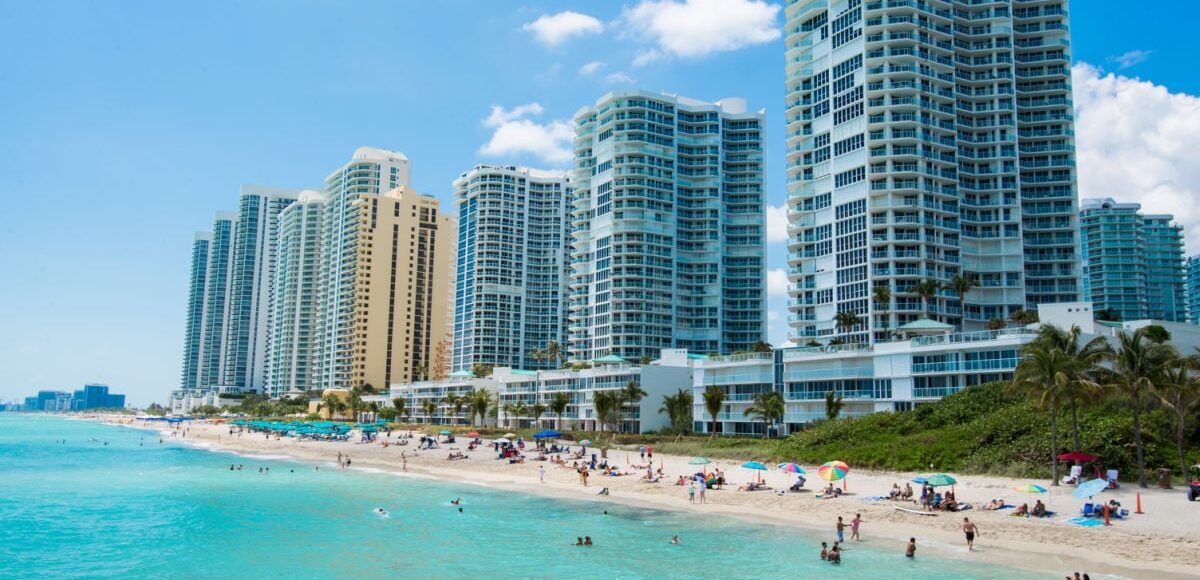 People swimming at nice beach in Sunny Isles, FL